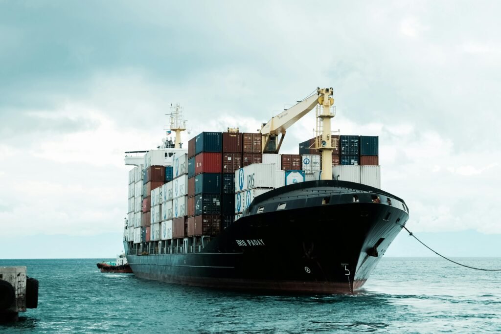 A distant view of large ships, containers, or trucks, illustrating logistics and trade